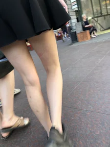 Slim pale legs, street candid girl wearing a skirt