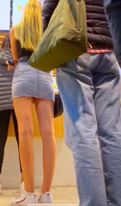 Hot blonde girl flashing her panties under the short denim skirt at the mall