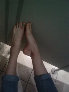 Bare Feet in a Public Toilet Cubicle