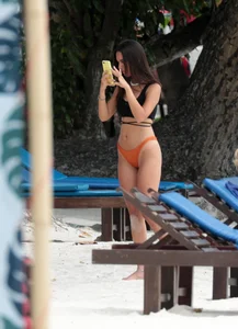 Sexy brunette friends on the beach in bikinis with great bodies