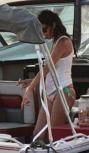 Bikini babe on a boat with a wet see through white shirt showing her tits