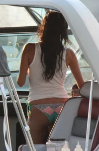 Bikini babe on a boat with a wet see through white shirt showing her tits
