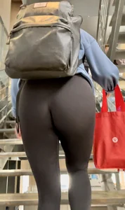 College girl going up the stairs with leggings and pink crocs
