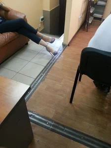 Candid Girl on the Leather Couch, Long Crossed Legs in Stiletto Shoes And Tight Pants