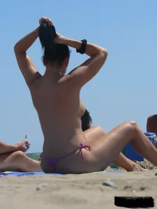 Purple thong topless lady on the beach gets oiled up by her husband