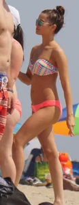 Two sexy girls in peach and pink bikinis on the beach