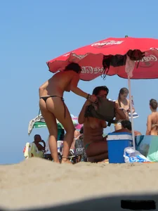 2 topless thonged sexy friends on the beach with great bodies