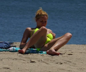 Sexy ass blonde milf on the beach in a thong with cameltoe and bending over