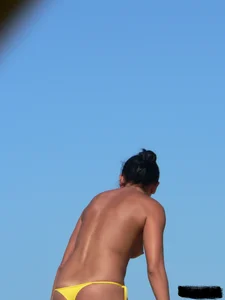 Bunch of sexy babes on the beach topless and in thong bikinis