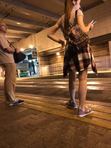 Cute Teen in Shorts on the Tram Stop