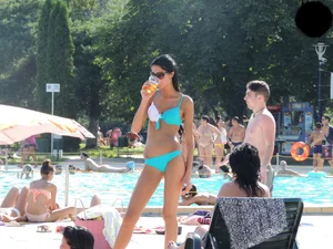 Tall and skinny brunette babe at the pool in a teal thong bikini