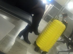 Crossed Legs in Black Pantyhose And High-Heeled Shoes Station Creepshot