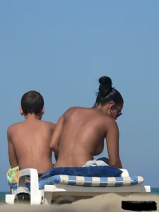 Hot ass topless beach girl with great tits lets her little brother oil up her ass in thong bikini