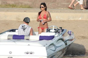 Brunette on a boat in red thong bikini with a tight little ass