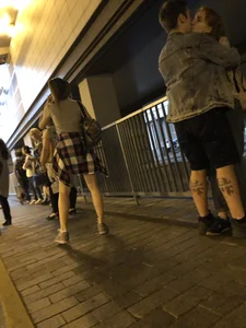 Cute Teen in Shorts on the Tram Stop
