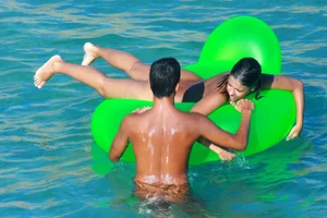 FKK Nudists playing in the water with floater