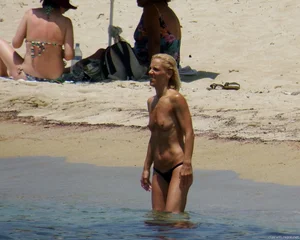 Small boobed topless milf on the beach