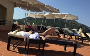 Blonde laying out in a blue bikini with a sexy body