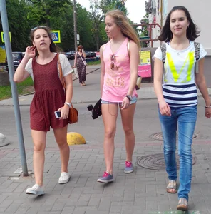 Girls Walking on the City Street in Summer Clothes