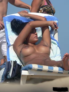 Hot ass topless beach girl with great tits lets her little brother oil up her ass in thong bikini