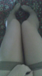 Young Girl’s Legs in Fishnet Stockings Home Selfie