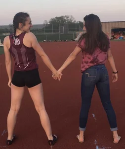 Two teens holding hands