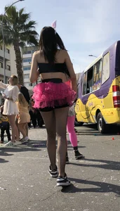 Hot carnival girl in in a top, mini shorts with pink frill and awesome legs in fishnet pantyhose