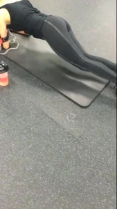 Sexy gym girl with a nice body in leggings as she works out