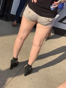 Bunch of girls in various outfits at a Cardinals baseball game