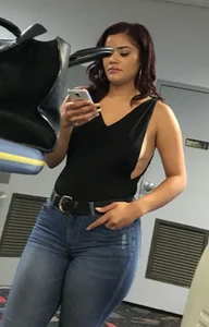 Thick brunette in tight jeans and showing some side boob