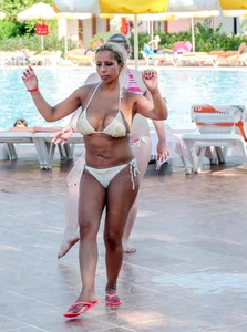Big boobed blonde milf dancing by the pool in a bikini