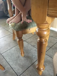 Girl Sitting in a Chair with Bare Feet Candid Closeup