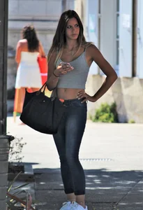 Sexy blonde girl in tight jeans and showing midriff