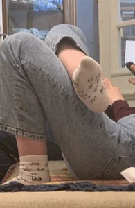 Teen Girl in Jeans And Dirty White Socks Lying With Crossed Legs on the Couch Home Creepshot