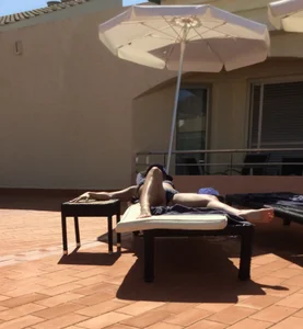 Blonde laying out in a blue bikini with a sexy body
