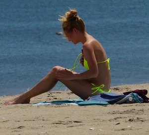 Sexy ass blonde milf on the beach in a thong with cameltoe and bending over