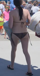 Girl in a tiny brown floral bikini showing some cheek and crack
