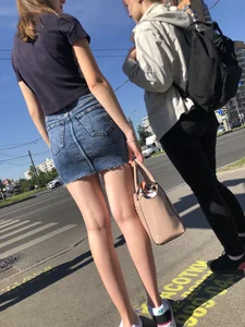 Cute Girl in a Short Denim Skirt Walking on a Street And Waiting on a Crosswalk Gallery