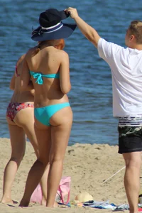 Couple of hot babes hanging out at the beach in bikinis