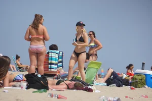 Two thick white girls in bikinis on the beach with big asses