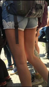 Teen booty in shorts and slim legs street closeup