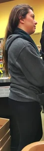 Fit shopping brunette girl in leggings and a hoodie with a nice ass