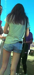 Skinny girl with purple hair in denim shorts