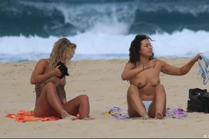 Sexy girls topless on a nude beach showing their nice tits