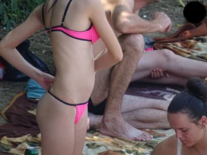 Beautiful and sexy teen in pink thong bikini