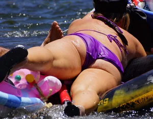 Sexy party girls in bikinis on a lake