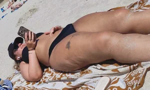 Milfs and girls resting at the beach in sexy bikinis