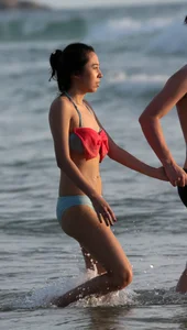Cute Asian in bikini on the beach with her boyfriend