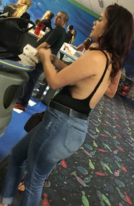 Thick brunette in tight jeans and showing some side boob