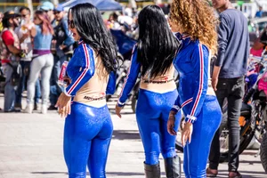 Sexy car models in tight shiny blue legging type pants